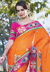 Take a look on the changing fashion of the season. This dark orange faux crepe jacquard saree have beautiful embroidery patch work which is embellished with resham, zari, stone, beads and lace work. Fabulous designed embroidery gives you an ethnic look and increasing your beauty. Contrasting pink art silk blouse is available. Slight Color variations are possible due to differing screen and photograph resolutions.
