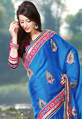 The traditional patterns used on this saree maintain the ethnic look. This blue faux crepe jacquard saree have beautiful embroidery patch work which is embellished with resham, zari, stone, beads and lace work. Fabulous designed embroidery gives you an ethnic look and increasing your beauty. Contrasting dark pink art silk blouse is available. Slight Color variations are possible due to differing screen and photograph resolutions.