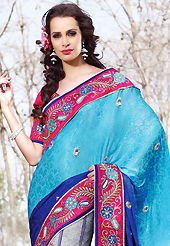Let your personality articulate for you with this amazing embroidered saree. This light blue, blue and grey faux georgette jacquard lehenga style saree have beautiful embroidery patch work which is embellished with resham, zari, stone, beads and lace work. Fabulous designed embroidery gives you an ethnic look and increasing your beauty. Contrasting dark pink art silk blouse is available. Slight Color variations are possible due to differing screen and photograph resolutions.