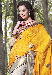 Welcome to the new era of Indian fashion wear. This dark yellow and off white art silk jacquard and net saree have beautiful embroidery patch work which is embellished with resham, stone, beads and lace work. Fabulous designed embroidery gives you an ethnic look and increasing your beauty. Contrasting red and off white art silk and net blouse is available. Slight Color variations are possible due to differing screen and photograph resolutions.