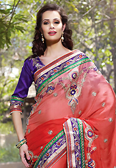 Try out this year top trend, glowing, bold and natural collection. This shaded red faux crepe jacquard saree have beautiful embroidery patch work which is embellished with resham, stone, beads and lace work. Fabulous designed embroidery gives you an ethnic look and increasing your beauty. Contrasting purple art silk blouse is available. Slight Color variations are possible due to differing screen and photograph resolutions.