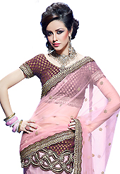 Dreamy variation on shape and forms compliment your style with tradition. This light pink net lehenga style saree have beautiful embroidery patch work which is embellished with resham, zari, sequins, stone and beads work. Fabulous designed embroidery gives you an ethnic look and increasing your beauty. Matching purple brocade blouse is available. Slight Color variations are possible due to differing screen and photograph resolutions.
