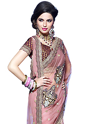 Take a look on the changing fashion of the season. This pink net and viscose lehenga style saree have beautiful embroidery patch work which is embellished with resham, zari, sequins and stone work. Fabulous designed embroidery gives you an ethnic look and increasing your beauty. Matching blouse is available. Slight Color variations are possible due to differing screen and photograph resolutions.
