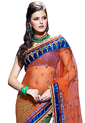 Your search for elegant look ends here with this lovely saree. This orange and dusty green net and faux georgette saree have beautiful embroidery patch work which is embellished with resham, zari, sequins, stone and lace work. Fabulous designed embroidery gives you an ethnic look and increasing your beauty. Contrasting blue brocade blouse is available. Slight Color variations are possible due to differing screen and photograph resolutions.
