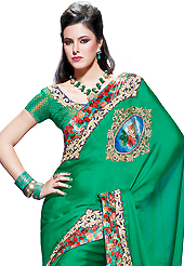 A desire that evokes a sense of belonging with a striking details. This green faux chiffon saree have beautiful embroidery patch work which is embellished with resham, zari and stone work. Fabulous designed embroidery gives you an ethnic look and increasing your beauty. Matching blouse is available. Slight Color variations are possible due to differing screen and photograph resolutions.