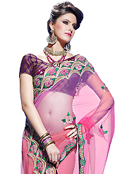 Style and trend will be at the peak of your beauty when you adorn this saree. This shaded pink net saree have beautiful embroidery patch work which is embellished with resham, zari, stone, beads and latken work. Fabulous designed embroidery gives you an ethnic look and increasing your beauty. Contrasting purple brocade blouse is available. Slight Color variations are possible due to differing screen and photograph resolutions.