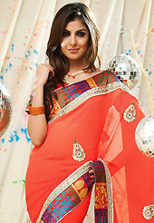 It is color this season and bright shaded suits are really something that is totally in vogue. This deep orange faux chiffon saree have beautiful embroidery patch work which is embellished with zari, stone and lace work. Fabulous designed embroidery gives you an ethnic look and increasing your beauty. Matching blouse is available. Slight Color variations are possible due to differing screen and photograph resolutions.