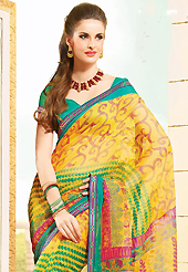 The most radiant carnival of style and beauty. This beautiful yellow super net saree is nicely designed with floral, abstract, leaf like print and graceful patch border. Beautiful print work on saree make attractive to impress all. It will enhance your personality and gives you a singular look. Contrasting green blouse is available with this saree. Slight color variations are due to differing screen and photography resolution.