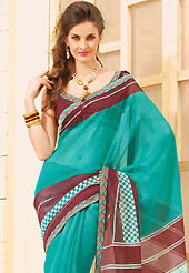 An endearing splash oh colors look gorgeous tridimensional charm. This beautiful turquoise and maroon super net saree is nicely designed with abstract, check print and graceful patch border. Beautiful print work on saree make attractive to impress all. It will enhance your personality and gives you a singular look. Matching blouse is available with this saree. Slight color variations are due to differing screen and photography resolution.