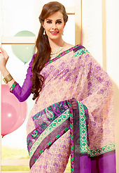Make a trendy look with this classic printed saree. This beautiful cream and purple super net saree is nicely designed with floral, paisley print and graceful patch border. Beautiful print work on saree make attractive to impress all. It will enhance your personality and gives you a singular look. Matching blouse is available with this saree. Slight color variations are due to differing screen and photography resolution.
