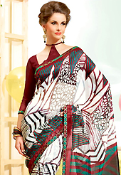 Ultimate collection of embroidered sarees with fabulous style. This beautiful off white super net saree is nicely designed with geometric, leaf like print and graceful patch border. Beautiful print work on saree make attractive to impress all. It will enhance your personality and gives you a singular look. Contrasting maroon blouse is available with this saree. Slight color variations are due to differing screen and photography resolution.