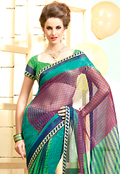 Envelope yourself in classic look with this charming saree. This beautiful green and purple super net saree is nicely designed with geometric print and graceful patch border. Beautiful print work on saree make attractive to impress all. It will enhance your personality and gives you a singular look. Matching blouse is available with this saree. Slight color variations are due to differing screen and photography resolution.