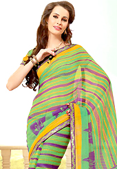 Make a trendy look with this classic printed saree. This beautiful green and purple super net saree is nicely designed with floral, stripe print and graceful patch border. Beautiful print work on saree make attractive to impress all. It will enhance your personality and gives you a singular look. Matching blouse is available with this saree. Slight color variations are due to differing screen and photography resolution.