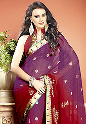 Ultimate collection of embroidered sarees with fabulous style. This beautiful shaded purple and red faux georgette saree is nicely designed with abstract, gold print and graceful patch border. Beautiful print work on saree make attractive to impress all. It will enhance your personality and gives you a singular look. Matching blouse is available with this saree. Slight color variations are due to differing screen and photography resolution.