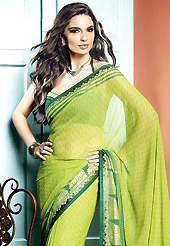 Dreamy variation on shape and forms compliment your style with tradition. This beautiful light green faux georgette saree is nicely designed with abstract, gold print and graceful patch border. Beautiful print work on saree make attractive to impress all. It will enhance your personality and gives you a singular look. Matching green blouse is available with this saree. Slight color variations are due to differing screen and photography resolution.