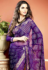 An occasion wear perfect is ready to rock you. This beautiful purple faux georgette saree is nicely designed with bandhej, gold print and graceful patch border. Beautiful print work on saree make attractive to impress all. It will enhance your personality and gives you a singular look. Matching blouse is available with this saree. Slight color variations are due to differing screen and photography resolution.