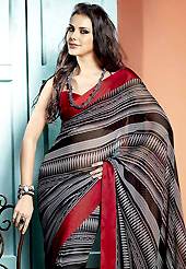 A desire that evokes a sense of belonging with a striking details. This beautiful black and light grey faux georgette saree is nicely designed with geometric print and graceful patch border. Beautiful print work on saree make attractive to impress all. It will enhance your personality and gives you a singular look. Contrasting red blouse is available with this saree. Slight color variations are due to differing screen and photography resolution.