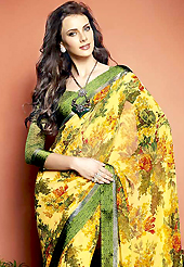 Keep the interest with this printed saree. This beautiful yellow faux georgette saree is nicely designed with flower print and graceful patch border. Beautiful print work on saree make attractive to impress all. It will enhance your personality and gives you a singular look. Contrasting green blouse is available with this saree. Slight color variations are due to differing screen and photography resolution.