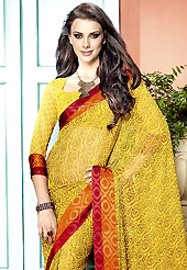 Printed sarees are the best choice for a girl to enhance her feminine look. This beautiful yellow faux georgette saree is nicely designed with floral, abstract, paisley print and graceful patch border. Beautiful print work on saree make attractive to impress all. It will enhance your personality and gives you a singular look. Matching blouse is available with this saree. Slight color variations are due to differing screen and photography resolution.