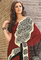 Exquisite combination of color, fabric can be seen here. This beautiful dark red, cream and black faux georgette saree is nicely designed with abstract print work. Beautiful print work on saree make attractive to impress all. It will enhance your personality and gives you a singular look. Matching blouse is available with this saree. Slight color variations are due to differing screen and photography resolution.