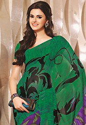 Style and trend will be at the peak of your beauty when you adorn this saree. This beautiful green and purple faux georgette saree is nicely designed with abstract print work. Beautiful print work on saree make attractive to impress all. It will enhance your personality and gives you a singular look. Matching blouse is available with this saree. Slight color variations are due to differing screen and photography resolution.