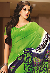 Get ready to sizzle all around you by sparkling sareen. This beautiful green and navy blue faux georgette saree is nicely designed with floral and abstract print work. Beautiful print work on saree make attractive to impress all. It will enhance your personality and gives you a singular look. Matching blouse is available with this saree. Slight color variations are due to differing screen and photography resolution.