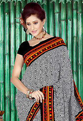 The traditional patterns used on this saree maintain the ethnic look. This beautiful white, orange and black faux crepe saree is nicely designed with abstract print work. Beautiful print work on saree make attractive to impress all. Matching black blouse is available with this saree. Slight color variations are due to differing screen and photography resolution.