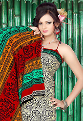 Keep the interest with this printed saree. This beautiful cream and green faux crepe saree is nicely designed with abstract print work. Beautiful print work on saree make attractive to impress all. Contrasting red blouse is available with this saree. Slight color variations are due to differing screen and photography resolution.