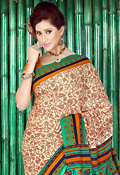 Make a trendy look with this classic printed saree. This beautiful dark cream and green faux crepe saree is nicely designed with floral print work. Beautiful print work on saree make attractive to impress all. Contrasting orange blouse is available with this saree. Slight color variations are due to differing screen and photography resolution.