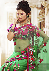 Envelope yourself in classic look with this charming saree. This green net saree is nicely designed with embroidered patch work is done with resham, zari and stone work. Beautiful embroidery work on saree make attractive to impress all. This saree gives you a modern and different look in fabulous style. Contrasting dark pink blouse is available. Slight color variations are possible due to differing screen and photograph resolution.