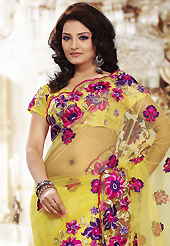 Elegance and innovation of designs crafted for you. This yellow net saree is nicely designed with embroidered patch work is done with resham and stone work. Beautiful embroidery work on saree make attractive to impress all. This saree gives you a modern and different look in fabulous style. Matching blouse is available. Slight color variations are possible due to differing screen and photograph resolution.