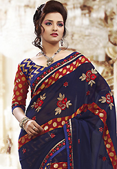 Exquisite combination of color, fabric can be seen here. This navy blue and maroon georgette, brasso net saree is nicely designed with embroidered patch work is done with resham, zari, sequins and stone work. Beautiful embroidery work on saree make attractive to impress all. This saree gives you a modern and different look in fabulous style. Matching blouse is available. Slight color variations are possible due to differing screen and photograph resolution.