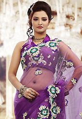 Get ready to sizzle all around you by sparkling saree. This shaded purle net saree is nicely designed with embroidered patch work is done with resham and stone work. Beautiful embroidery work on saree make attractive to impress all. This saree gives you a modern and different look in fabulous style. Matching blouse is available. Slight color variations are possible due to differing screen and photograph resolution.