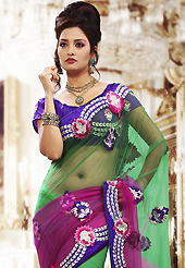 The evolution of style species collection spells pure femininity. This shaded green and pink net saree is nicely designed with embroidered patch work is done with resham, zari and stone work. Beautiful embroidery work on saree make attractive to impress all. This saree gives you a modern and different look in fabulous style. Contrasting purple blouse is available. Slight color variations are possible due to differing screen and photograph resolution.