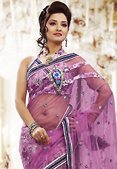 An occasion wear perfect is ready to rock you. This onion pink net and brasso saree is nicely designed with embroidered patch work is done with resham, zari and sequins work. Beautiful embroidery work on saree make attractive to impress all. This saree gives you a modern and different look in fabulous style. Matching blouse is available. Slight color variations are possible due to differing screen and photograph resolution.