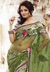 It is color this season and bright shaded suits are really something that is totally in vogue. This green net and brasso saree is nicely designed with embroidered patch work is done with resham, zari and sequins work. Beautiful embroidery work on saree make attractive to impress all. This saree gives you a modern and different look in fabulous style. Matching blouse is available. Slight color variations are possible due to differing screen and photograph resolution.