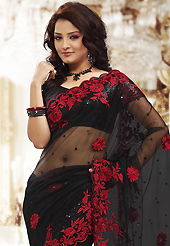 Ultimate collection of embroidery sarees with fabulous style. This black net saree is nicely designed with embroidered patch work is done with resham and sequins work. Beautiful embroidery work on saree make attractive to impress all. This saree gives you a modern and different look in fabulous style. Matching blouse is available. Slight color variations are possible due to differing screen and photograph resolution.