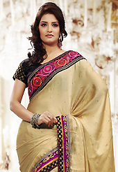 Take a look on the changing fashion of the season. This light fawn chiffon saree is nicely designed with embroidered patch work is done with resham, zari, stone and lace work. Beautiful embroidery work on saree make attractive to impress all. This saree gives you a modern and different look in fabulous style. Contrasting black blouse is available. Slight color variations are possible due to differing screen and photograph resolution.