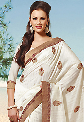 Take the fashion industry by storm in this beautiful embroidered saree. This black and maroon art silk and brocade saree is nicely designed with embroidered patch work is done with resham, zari and lace work. Beautiful embroidery work on saree make attractive to impress all. This saree gives you a modern and different look in fabulous style. Matching blouse is available. Slight color variations are possible due to differing screen and photograph resolution.