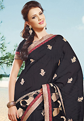 Attract all attentions with this embroidered saree. This black art silk saree is nicely designed with embroidered patch work is done with resham, zari and lace work. Beautiful embroidery work on saree make attractive to impress all. This saree gives you a modern and different look in fabulous style. Matching blouse is available. Slight color variations are possible due to differing screen and photograph resolution.