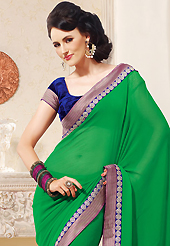 Envelope yourself in classic look with this charming saree. This green faux chiffon saree is nicely designed with embroidered patch work is done with zari and stone work. This saree gives you a modern and different look in fabulous style. Contrasting dark blue velvet blouse is available. Slight color variations are possible due to differing screen and photograph resolution.