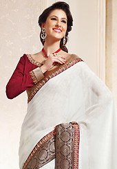 An occasion wear perfect is ready to rock you. This off white cotton saree is nicely designed with embroidered patch work is done with zari work. This saree gives you a modern and different look in fabulous style. Contrasting red blouse is available. Slight color variations are possible due to differing screen and photograph resolution.
