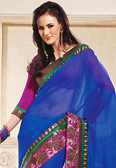 Elegance and innovation of designs crafted for you. This blue net saree is nicely designed with embroidered patch work is done with zari work. This saree gives you a modern and different look in fabulous style. Contrasting magenta blouse is available. Slight color variations are possible due to differing screen and photograph resolution.