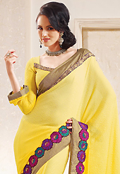 Exquisite combination of color, fabric can be seen here. This yellow faux chiffon saree is nicely designed with embroidered patch work is done with resham and zari work. This saree gives you a modern and different look in fabulous style. Matching blouse is available. Slight color variations are possible due to differing screen and photograph resolution.