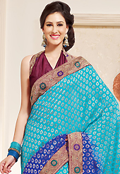 The traditional patterns used on this saree maintain the ethnic look. This shaded light blue and dark blue viscose georgette saree is nicely designed with embroidered patch work is done with resham work. This saree gives you a modern and different look in fabulous style. Contrasting burgundy blouse is available. Slight color variations are possible due to differing screen and photograph resolution.