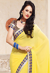 Ultimate collection of embroidery sarees with fabulous style. This yellow faux georgette saree is nicely designed with embroidered patch work is done with zari and stone work. This saree gives you a modern and different look in fabulous style. Matching blouse is available. Slight color variations are possible due to differing screen and photograph resolution.