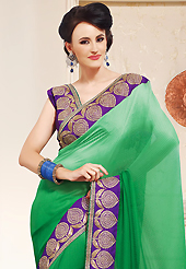 Try out this year top trend, glowing, bold and natural collection. This shaded green faux chiffon saree is nicely designed with embroidered patch work is done with zari, stone and lace work. This saree gives you a modern and different look in fabulous style. Contrasting purple blouse is available. Slight color variations are possible due to differing screen and photograph resolution.