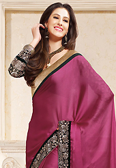 Welcome to the new era of Indian fashion wear. This deep pink satin saree is nicely designed with embroidered patch work is done with zari and lace work. This saree gives you a modern and different look in fabulous style. Contrasting black blouse is available. Slight color variations are possible due to differing screen and photograph resolution.
