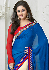 Welcome to the new era of Indian fashion wear. This blue and cream georgette jacquard saree is nicely designed with abstract print, zari, stone and patch bordered work. Beautiful embroidery work on saree make attractive to impress all. This saree gives you a modern and different look in fabulous style. Contrasting red blouse is available. Slight color variations are possible due to differing screen and photograph resolution.
