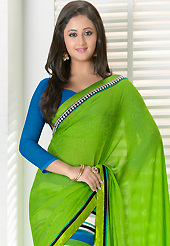 The evolution of style species collection spells pure femininity. This light green and off white georgette jacquard saree is nicely designed with stripe print, stone and patch bordered work. Beautiful embroidery work on saree make attractive to impress all. This saree gives you a modern and different look in fabulous style. Contrasting blue blouse is available. Slight color variations are possible due to differing screen and photograph resolution.